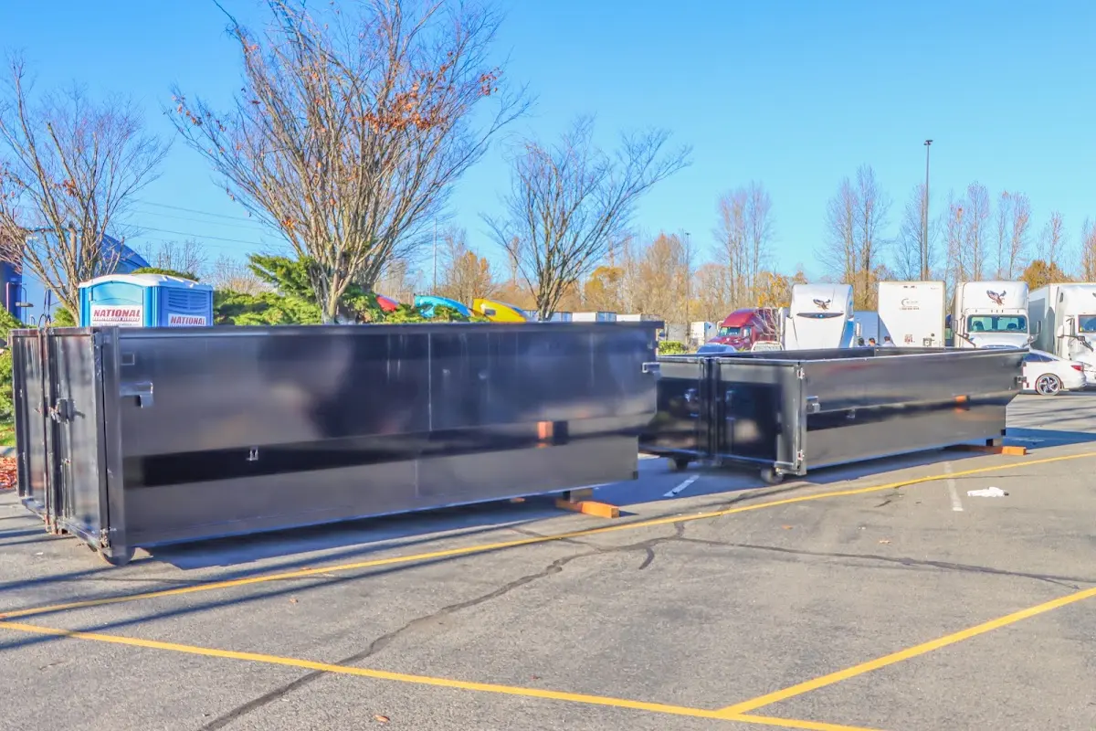 Professional dumpster rental service with roll-off container on residential driveway in Crofton